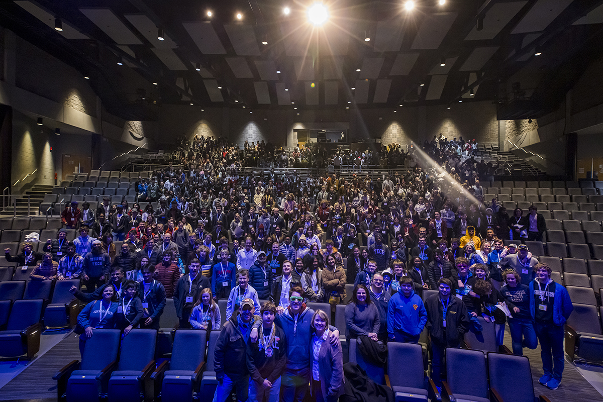 Hundreds of parents sit in theater seats